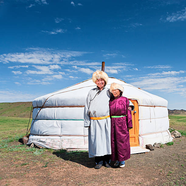 istock Mongolian couple in national clothing next to ger 584777024