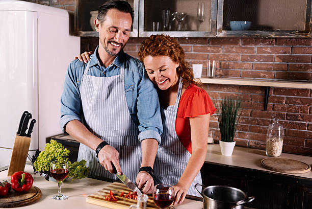 istock Wife and husband cooking together 584777258