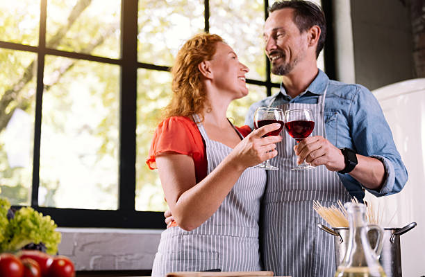 istock Man and woman clinking glasses 584778742