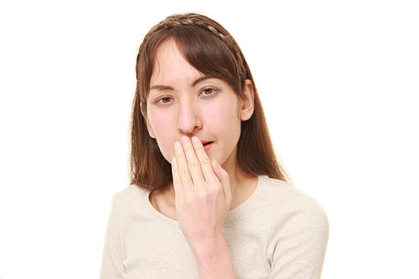 istock woman making the speak no evil gesture 584778898