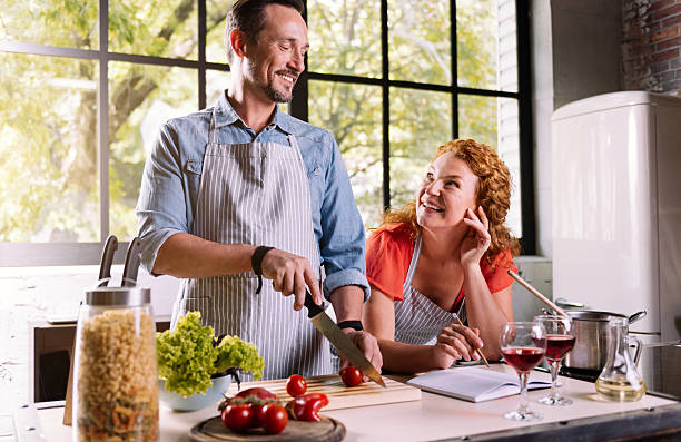 istock Couple cooking together a dinner 584779066