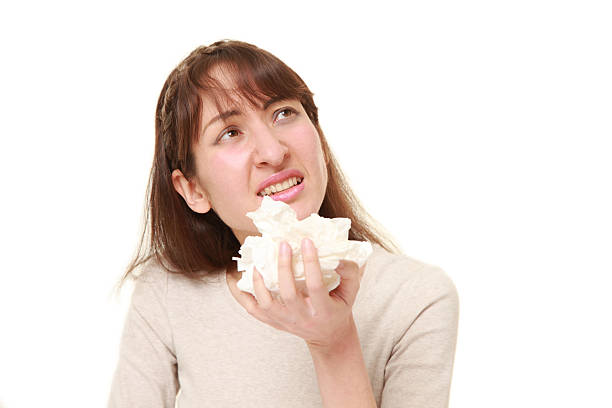 istock young woman with an allergy sneezing into tissue 584779810
