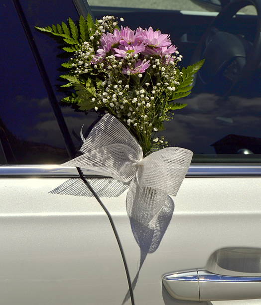istock Bridal bouquet on wedding car door 584780154
