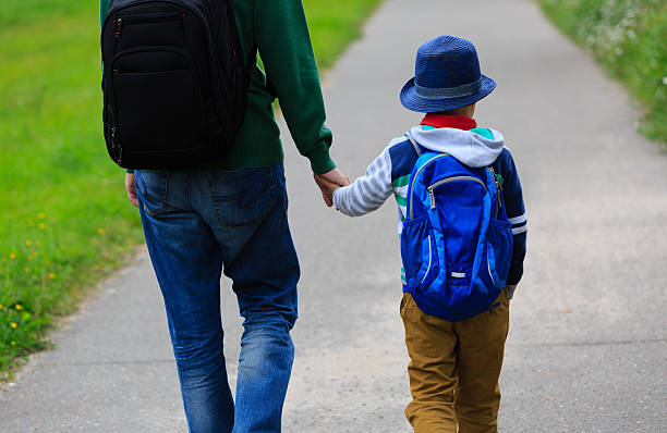 istock father walking son to school or daycare 584780966