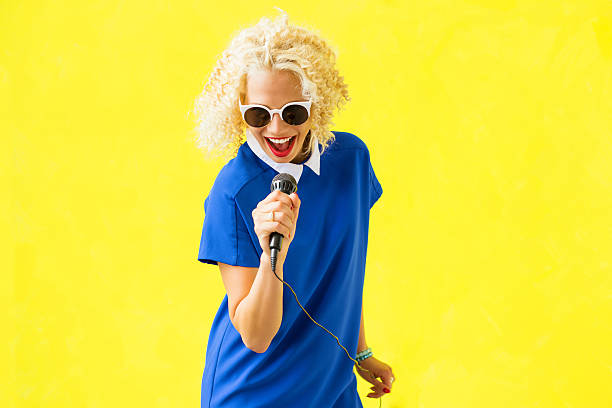 Hipster woman singing in microphone Hipster woman singing in microphone hair band stock pictures, royalty-free photos & images