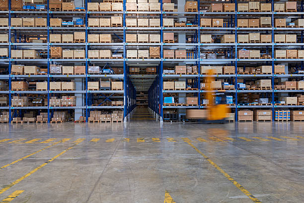 istock Forklift carrying cardboard box in warehouse. 584782528