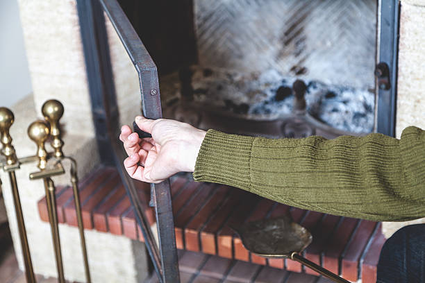 istock Hand man opens door of fireplace 584784188