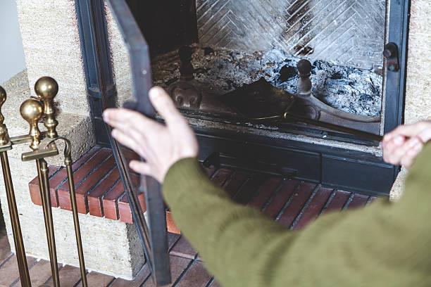 istock Man cleans brass fireplace shovel 584785536