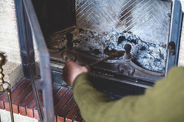 istock Hand picking up man from ashes on fireplace shovel 584786210