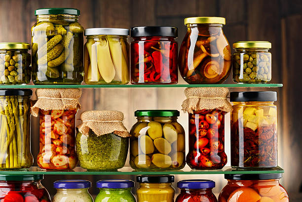 istock Jars with variety of pickled vegetables. 584786676