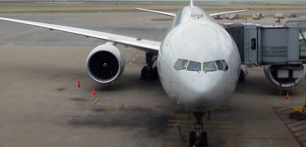 istock Big Airplane Parked At Airport Loading Gate 584787852
