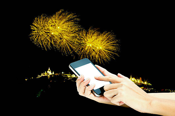 istock hand use smart phone  with image of firework as 584788998