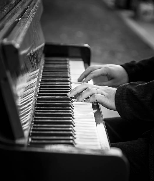 istock Hands of man playing an old piano 584789806