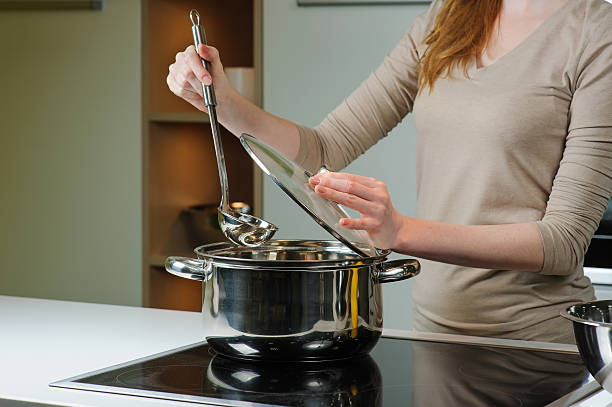istock Woman cooks the soup in the kitchen 584789842
