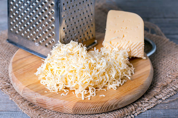 grated cheese with grater - recipe ingredient grater cheese grater imagens e fotografias de stock