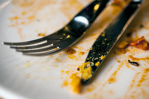 istock Dirty white plate, knife and fork at a cafe 584791244