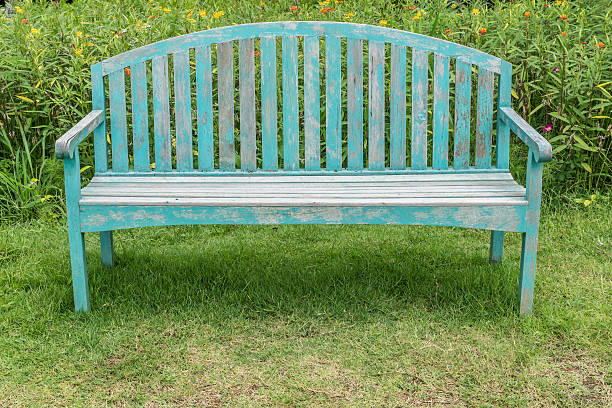 istock Wood bench on green grass floor 584846578
