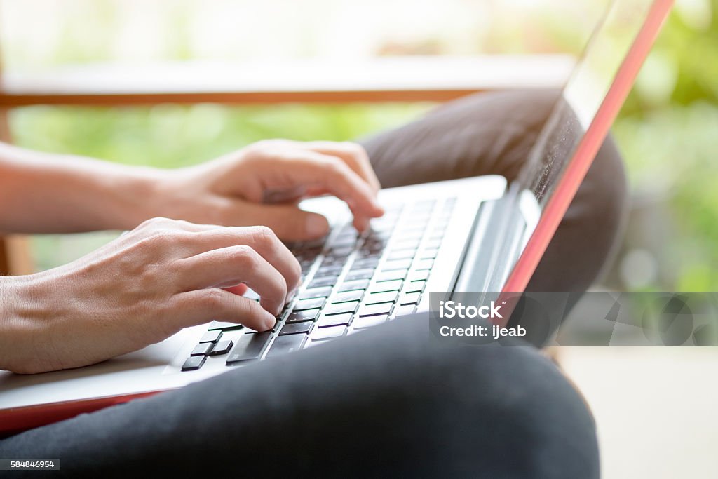Young woman using computer laptop. Young woman using computer laptop for online learning or business contact. Adult Stock Photo