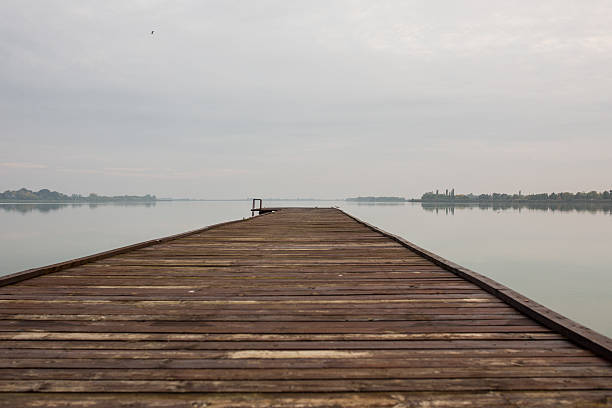 istock Pier with no people on a lake. 584847178