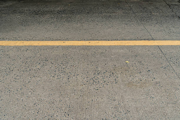 istock Concrete road with yellow sign line 584849464