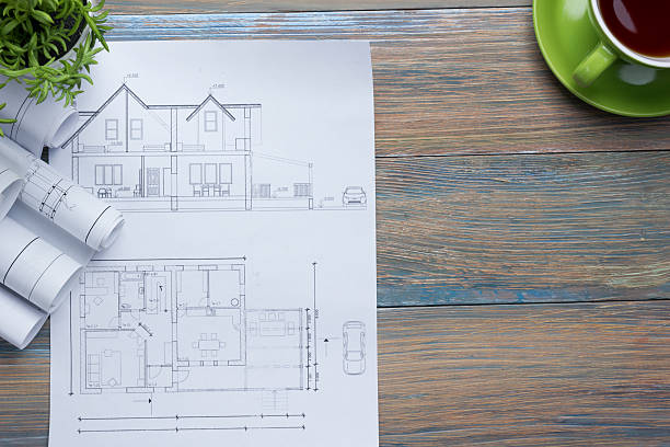 istock Architect worplace top view. Architectural project, blueprints, blueprint rolls and 584850014