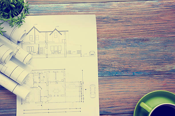 istock Architect worplace top view. Architectural project, blueprints, blueprint rolls and 584850486