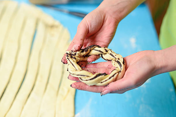 istock Woman hand preparing poppy seed buns 584850830