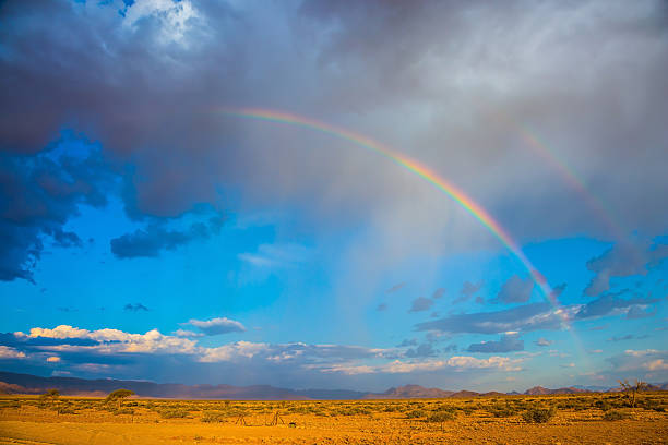istock Rainbow crossed the sky over the desert 584851260
