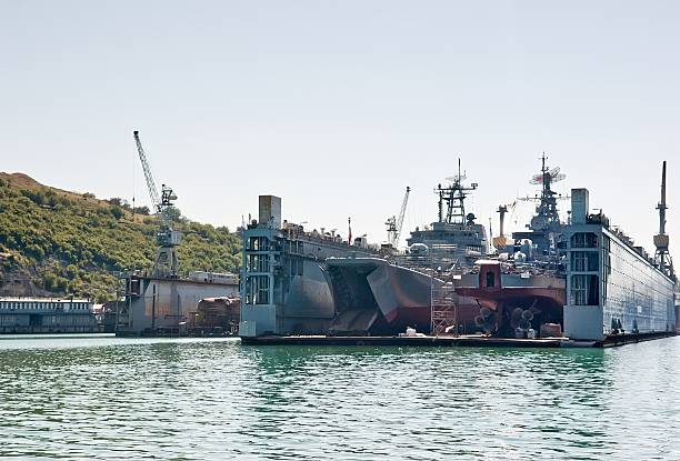 istock Floating dry dock with two landing crafts. 584852256