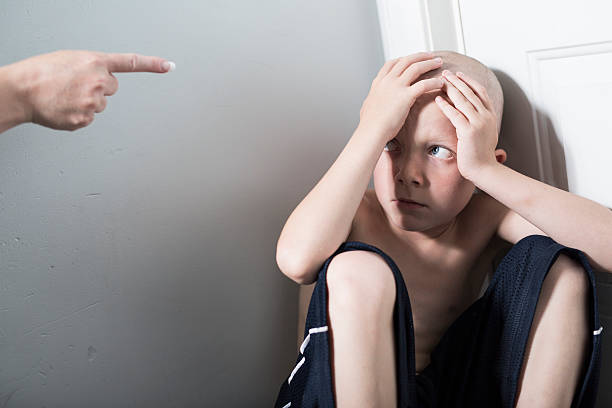 istock Neglected lonely child leaning at the wall 584854368