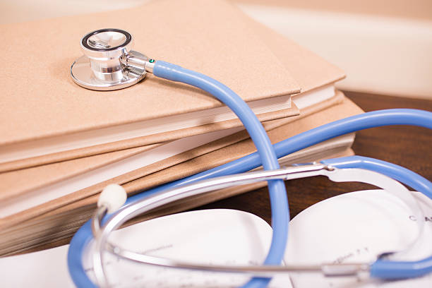 istock Doctor's stethoscope on desk with books to read or study. 584854650