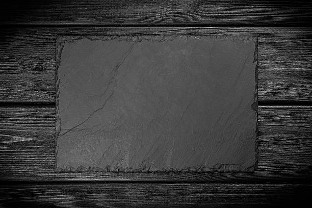 istock Slate board on black wood 584856696