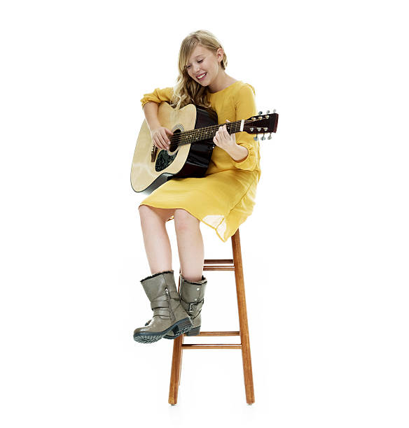 istock Smiling little girl playing guitar 584856862
