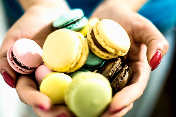 Delicious cakes macaroon in women hands. Colorful macaroons.