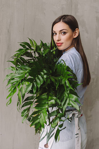 istock Florist workspace: caucasian woman making floral decorations 584857480