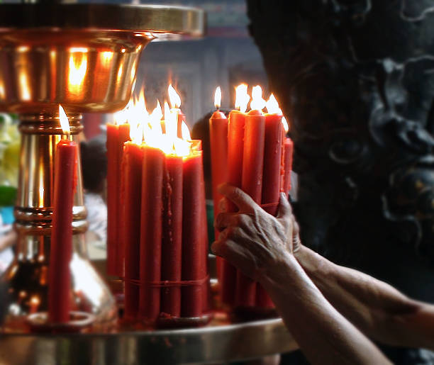 istock Hand Holding Candle In Temple 584857808