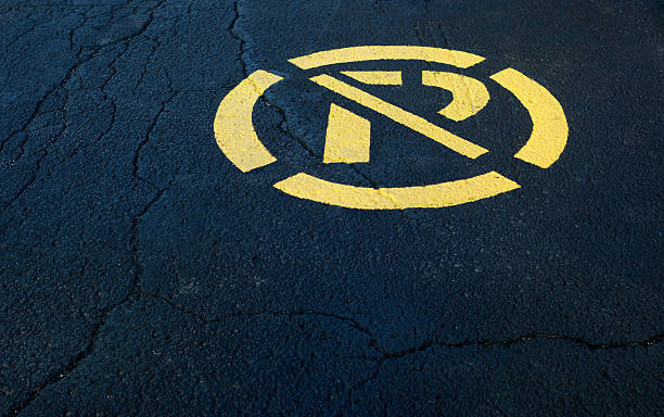 istock no parking sign painted in yellow on black asphalt 584858100