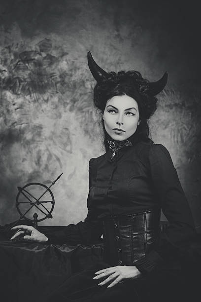 Black and white retro photo, woman demon, devil. Girl with stock photo