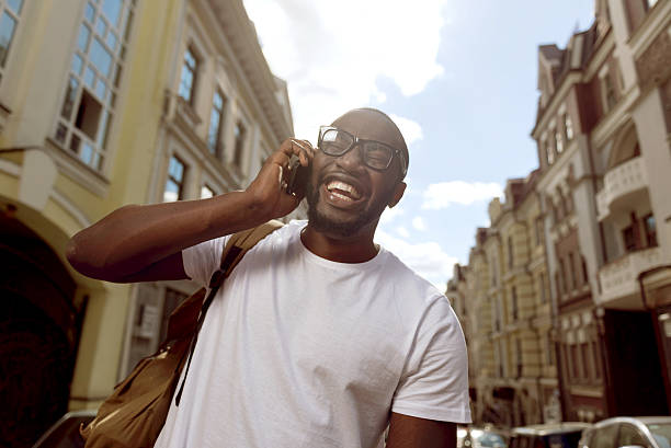 istock Overjoyed smiling man talking on cell phone 584860966