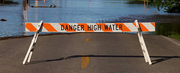 Danger High Water Flooding Street closure due to flood waters in Wichita, Kansas. wichita photos stock pictures, royalty-free photos & images