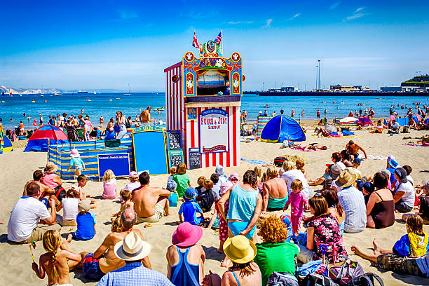 people watching the punch and judy show at weymouth, uk - costume stage costume sunlight carnival imagens e fotografias de stock