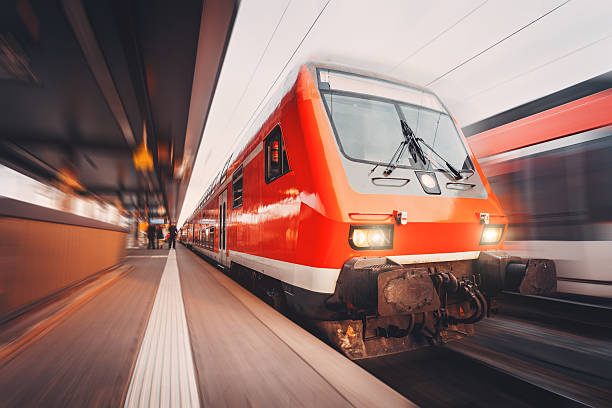 istock Modern high speed red passenger trains at sunset. Railway station 584865596