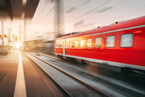 istock Modern high speed red passenger train at sunset. Railway station 584865638
