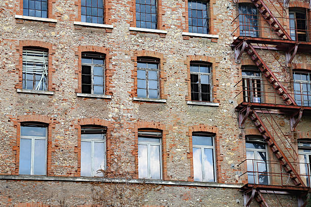 istock dilapidated industrial building with rusty fire escape with faci 584865756