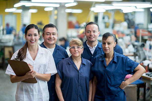 istock Group of people working at a factory 584866412