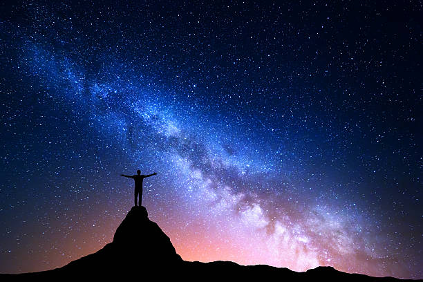 istock Silhouette of a standing man on the mountain peak 584867160