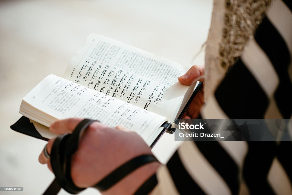 Daily prayer at Western Wall, Old City, Jersalem, Israel Religious Jewish believer reading Torah and praying at Wailing Wall (Kotel) in Jerusalem, Israel. Judaism Stock Photo