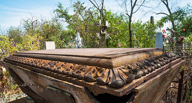 Old cast iron a gravestone has the likeness of the coffin on the old Russian Orthodox cemetery.
