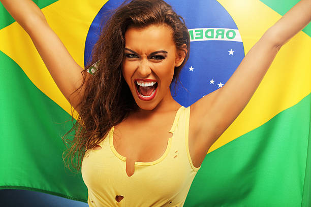istock Happy Brazilian fan cheering with flag 584869160