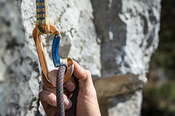 carabiner and climbing rope Carabiner, spit and climbing rope. Free climbing gear hook equipment photos stock pictures, royalty-free photos & images